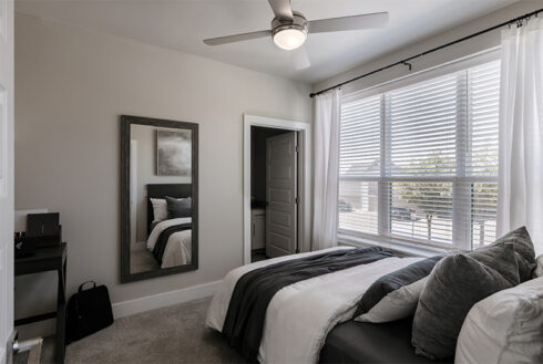 Furnished bedroom decorated with grey accent pieces