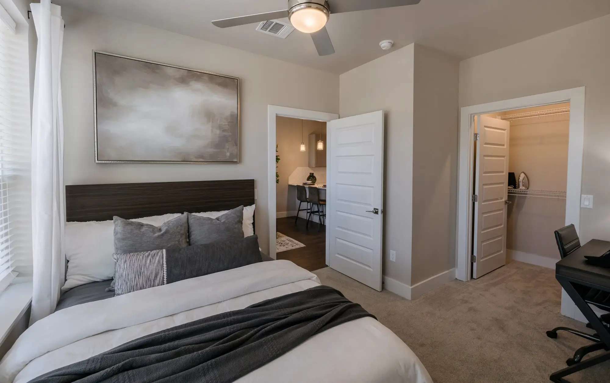 Bedroom with an upholstered headboard and en-suite doorway
