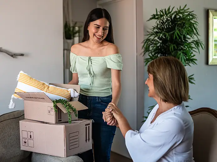 Young adults and mother packing for a move