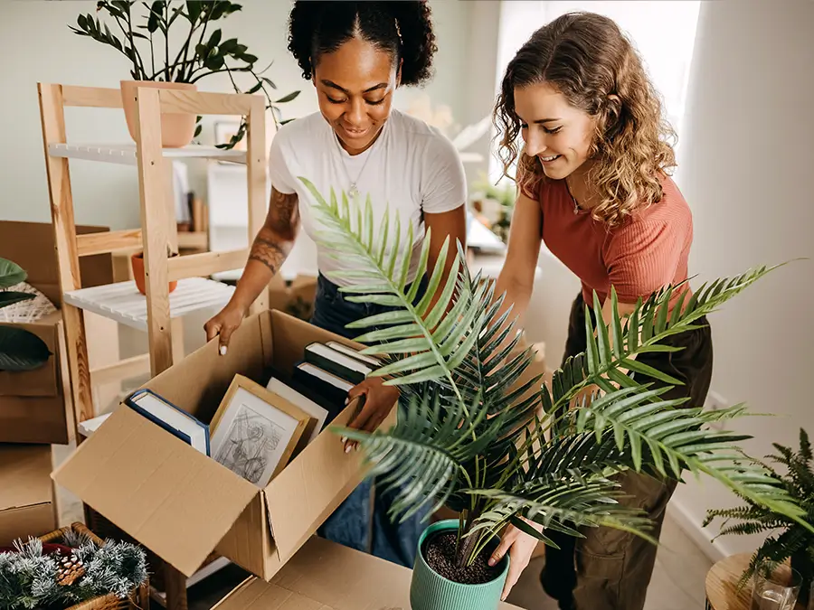 two young girls packing moving boxes